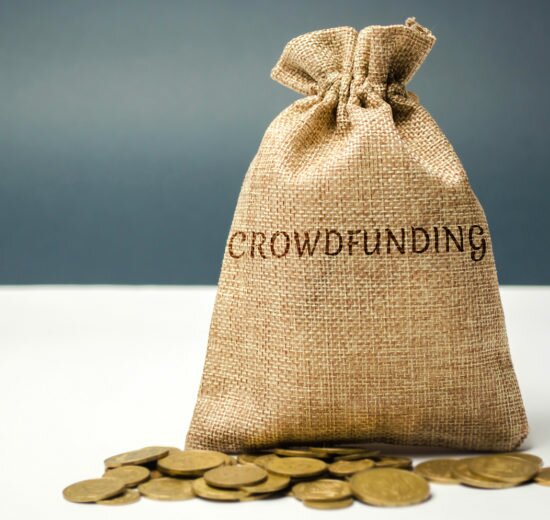 Money bag with coins with the word crowdfunding. Voluntary association of money or resources via the Internet. Support recipients. Financing start-up companies and small businesses. Co-investment